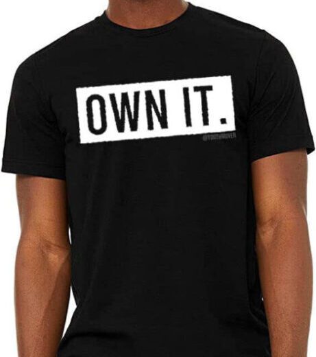 Black t-shirt with bold white text ‘OWN IT.’ on the front. Black t-shirt with bold white text 'OWN IT.' on the front.